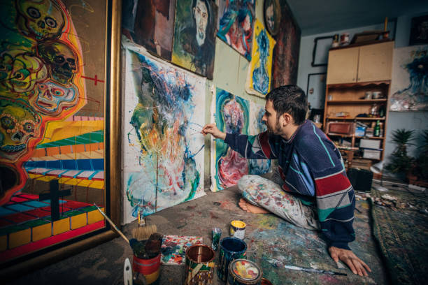 istock Man painting on the floor in home studio 1178557063