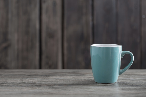 clean empty cup on old wooden background