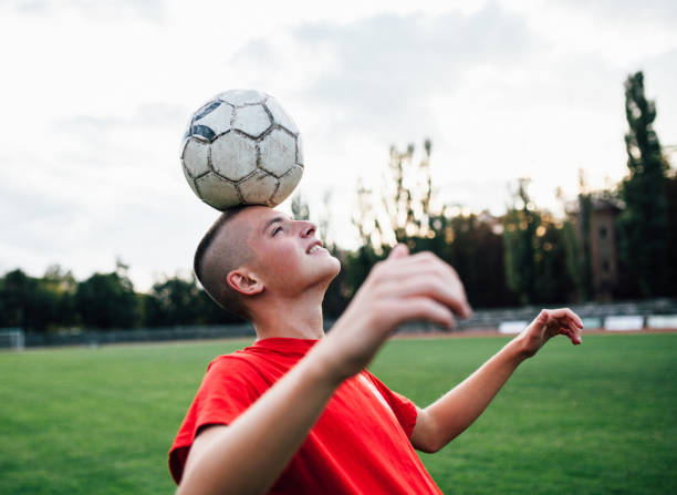 istock Young boy Heading Soccer Ball 1178558191