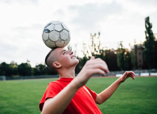 Young boy Heading Soccer Ball