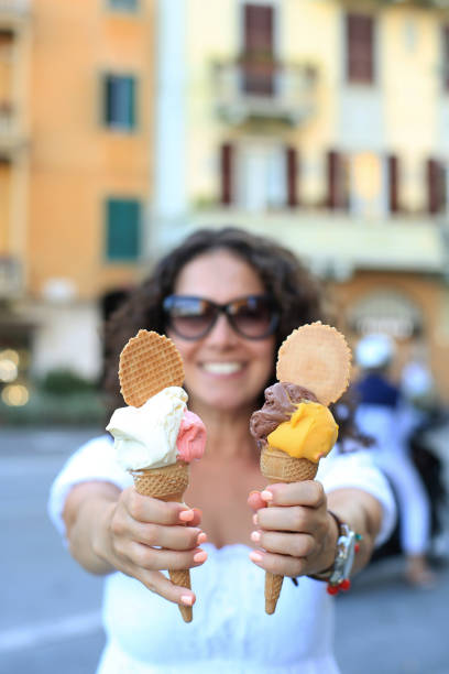 Beautiful girl holding an ice cream Beautiful girl holding an ice cream in Italy santa margherita ligure italy stock pictures, royalty-free photos & images