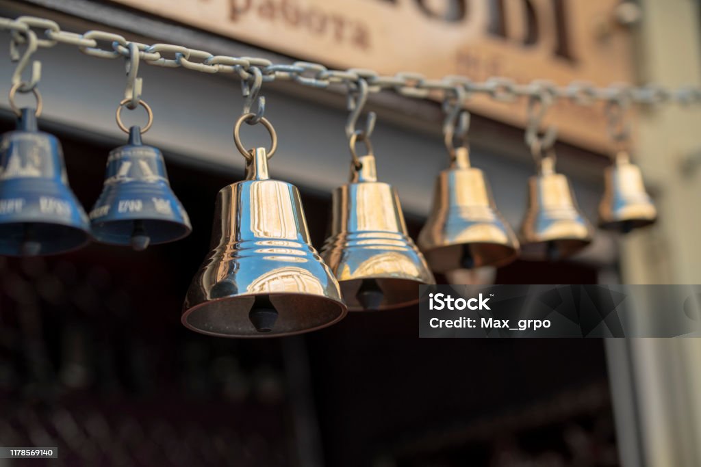 Bronze And Copper Made Small Bells Locked Together On The Chain Stock Photo  - Download Image Now - iStock