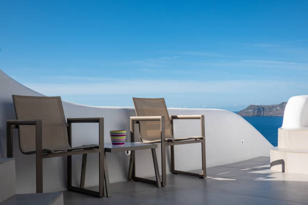 istock empty table and chair with blue sky in Santorini island, Greece 1178570213