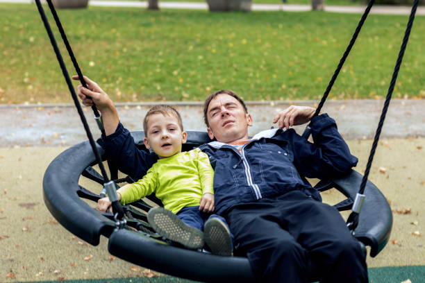 istock Dad and son on the playground. 1178570555