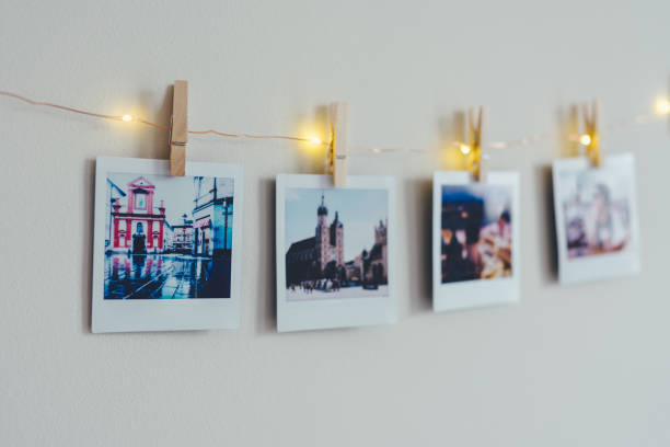 Instant photos on white background Instant photo prints hanging on string with clothespin in studio hanging photos stock pictures, royalty-free photos & images