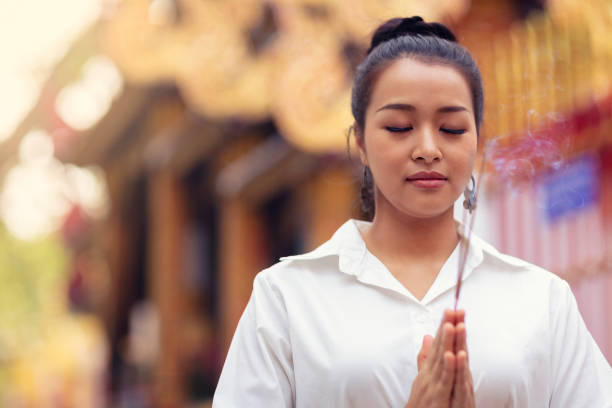 istock Buddhist woman visiting a temple 1178576147