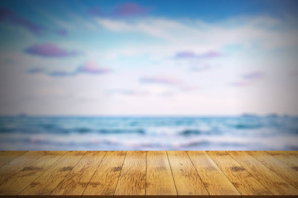 istock Empty wooden table in front with blurred background of sea view. 1178576397