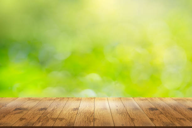 istock Empty wooden table in front with blur abstract green of garden. 1178576434