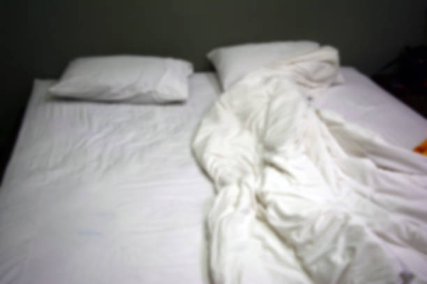 istock the blurred bed with wrinkle bed sheet ,quilt and pillow 1178578821