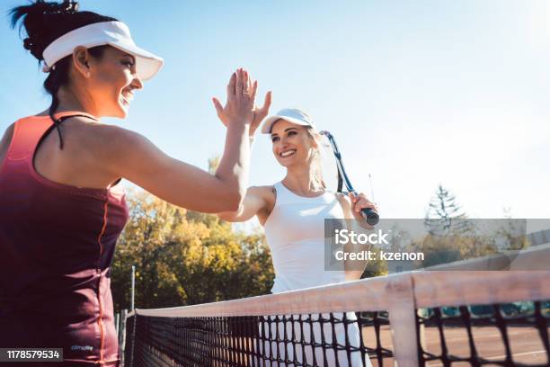 Women Giving High Five After A Good Match Of Tennis Stock Photo - Download Image Now