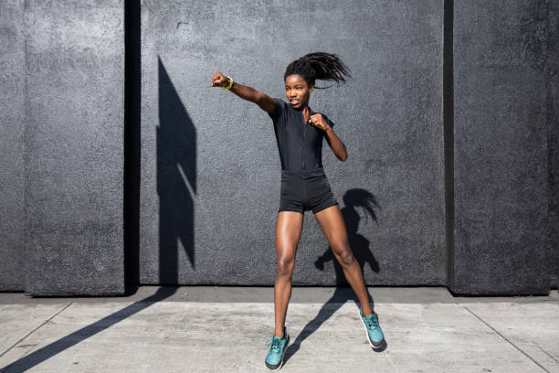 istock Afro american woman with dreadlocks in a great athletic shape working out and training hard outdoors 1178579577