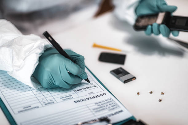 istock Forensics. Police Expert Examining Confiscated Mobile phone 1178580457