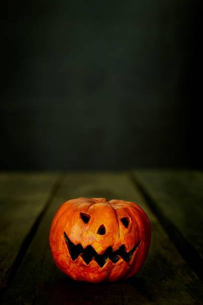 istock Halloween pumpkin head jack lantern on the wooden table 1178582358