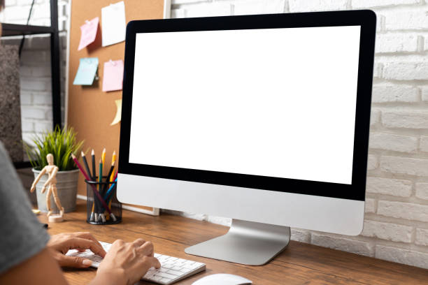 istock woman working empty screen computer on wood desk in home office. 1178583582