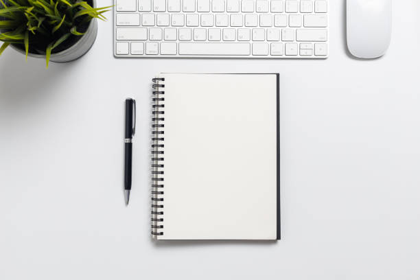 istock Top view, empty notebook and office supplies on the desk. 1178583643