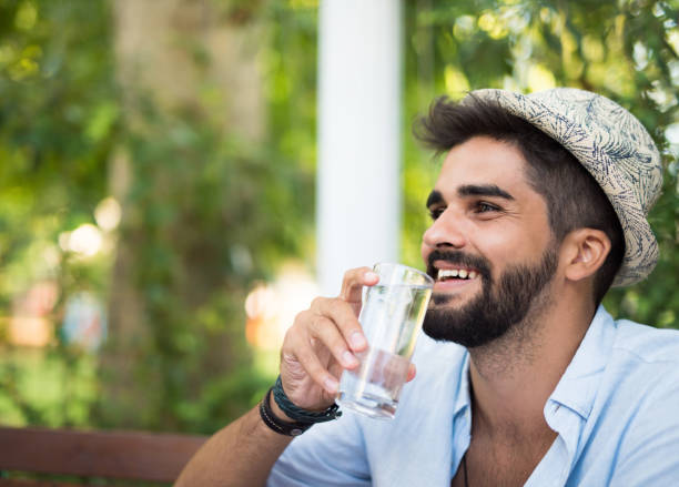 istock Happy young man drinking water outdoors. 1178584169