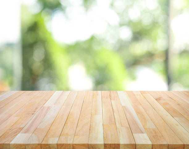 istock Empty wood table top on blur abstract green garden from window view background 1178585525