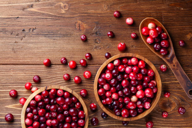 istock Cranberry in wooden bowl on rustic table from above. 1178588861