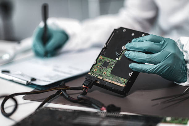 Forensic Science Technician Analyzing Evidence in Laboratory Forensic Science Investigator Examining Computer Hard Drive. Digital Forensic Science Concept. forensic science stock pictures, royalty-free photos & images