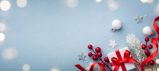 istock Christmas greeting card. Fir tree branches, holiday decorations and gift or present box top view. 1178589011