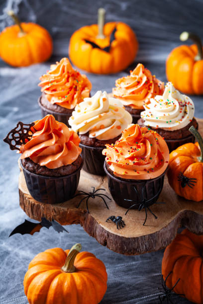 istock Halloween cupcakes and pumpkins on dark web background. Sweets for holiday party. 1178589105