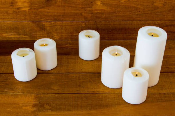 istock Large candles on wooden background 1178589751