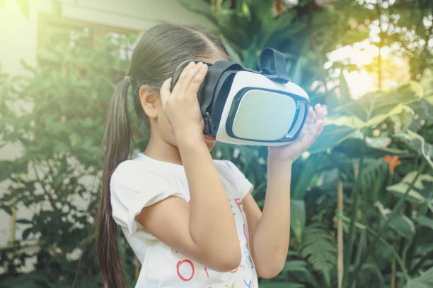 istock Girl kid wearing virtual reality goggles in home. Interacting VR headset Concept 1178589913