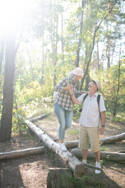 istock Loving husband supporting his wife standing on the tree roots 1178592781