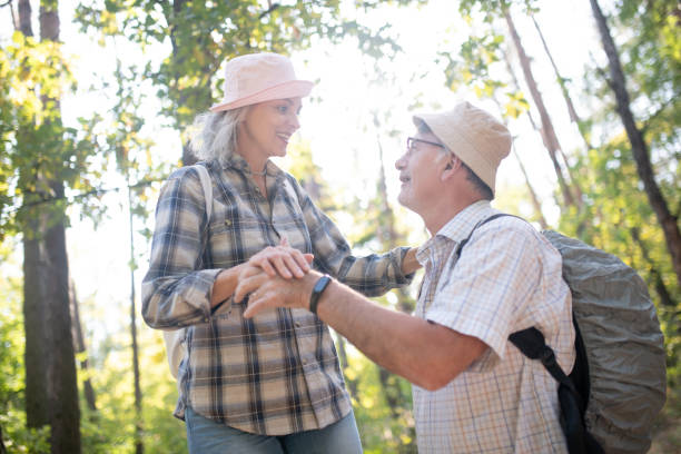 istock Husband supporting wife while walking in national park 1178592805
