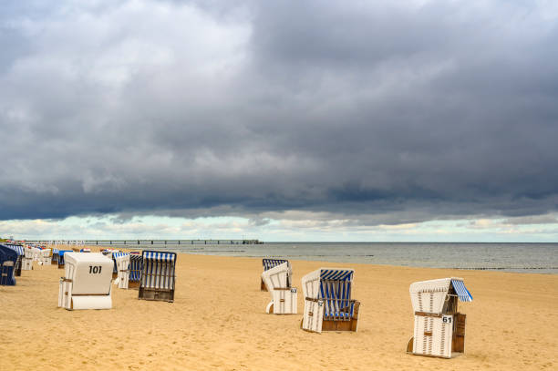 istock Lonely beach with beach chairs on Usedom overlooking the sea to dramatic looking storm clouds. 1178592848