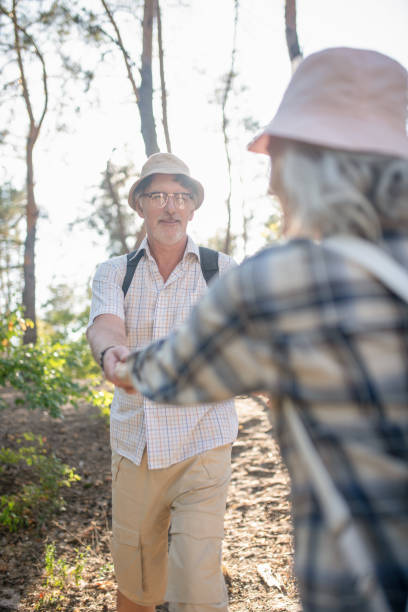 istock Husband holding his wife while hiking in the forest together 1178592905