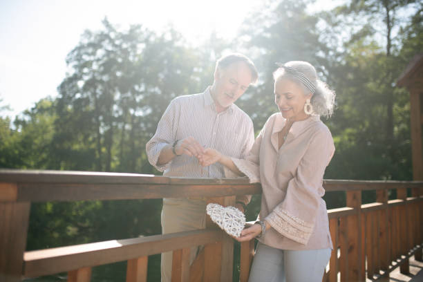 istock Mature adults smiling while leaving little heart on the bridge 1178593099