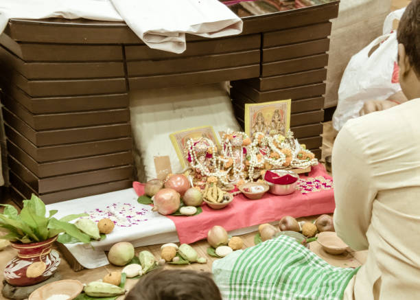 businessman doing diwali lakshmi ganesha puja vidhi (rituals) at dhanteres time at home. lakshmi is hindu goddess of wealth, fortune and prosperity. kolkata, west bengal, india - west indian culture imagens e fotografias de stock