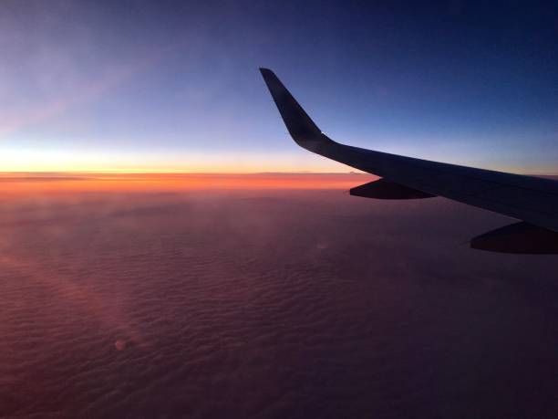 flying / mid-air sunrise / sky / aircraft wing / winglet - cloud mid air cloudscape aerial view imagens e fotografias de stock