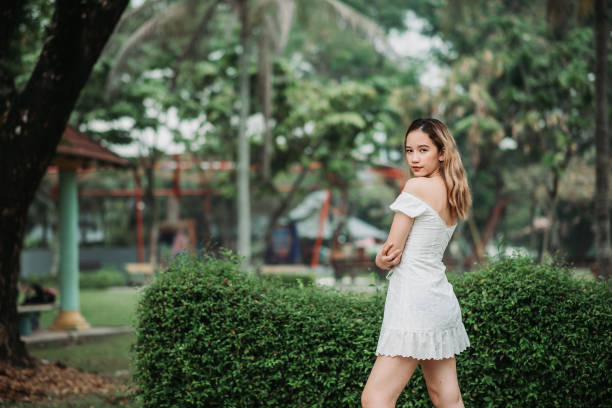 asian female teenager girl stand at public park beside playground - fashion fashion model asian ethnicity tall imagens e fotografias de stock