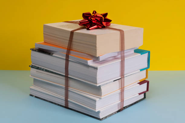 the gift of a pile of books bound by a ribbon and a bow