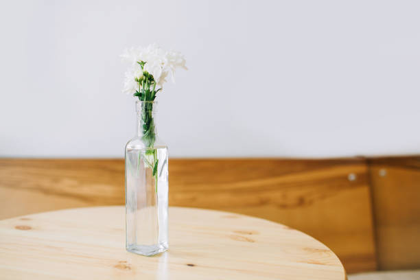 istock Vase with white flowers on a table. White background. 1178600531