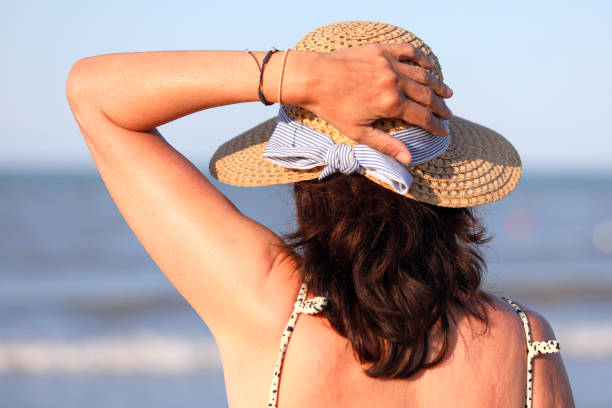 istock woman with straw hat 1178601118