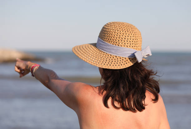 istock young woman with straw hat  in summer 1178601731