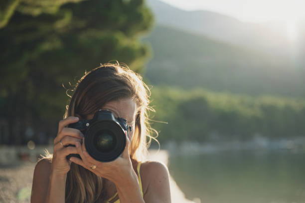 istock Young woman taking a photo directly at the camera 1178603328