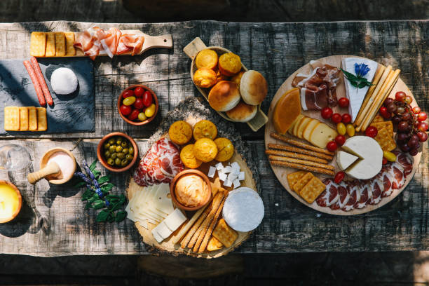 Overhead image of the picnic table, filled with various sorts of Mediterranean foods. Snacks, cheese, vegetables, meat, all nicely arranged for a healthy meal.