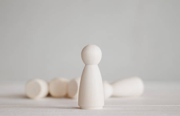 istock standing wooden doll in front of falling group 1178604641