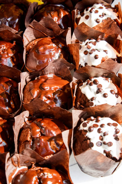 Chocolate muffins with chocolate chips in brown paper