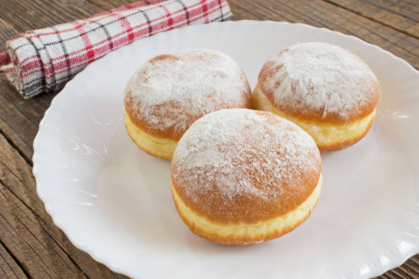 istock Berliner donuts in plate on wooden table 1178608211