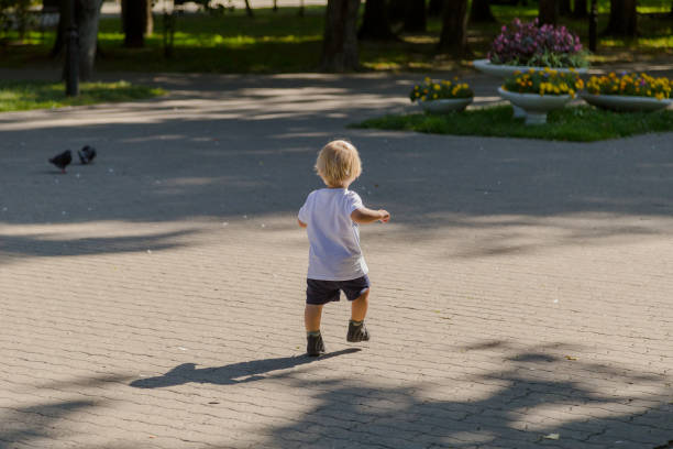 istock Little boy runs on the asphalt in the park 1178608823
