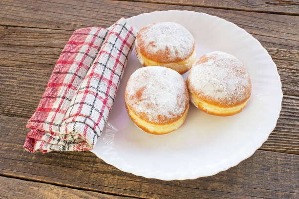 istock Berliner donuts in plate on wooden table 1178608930
