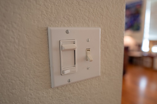 Dimmer switch and light switch in domestic room, September 24, 2019