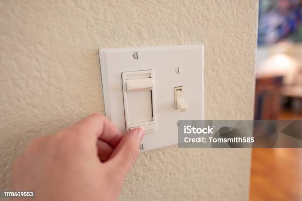 Pov Man Adjusting Dimmer Switch Stock Photo - Download Image Now - Dimmer Switch, Light Switch, Light - Natural Phenomenon