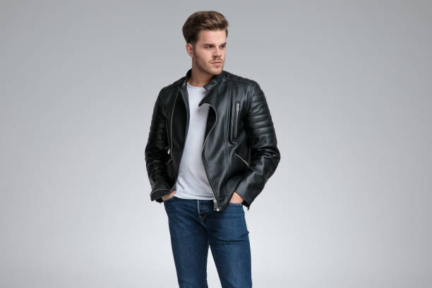 istock casual man standing with hands in pockets and looking away 1178609671