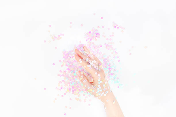 istock Pearl pastel confetti sparkles with woman hand 1178610422